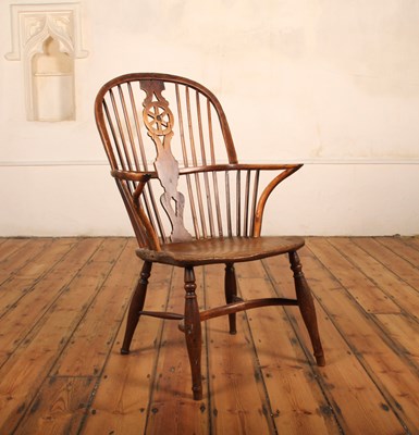 Lot 379 - A yew and elm seated wheelback Windsor chair,...