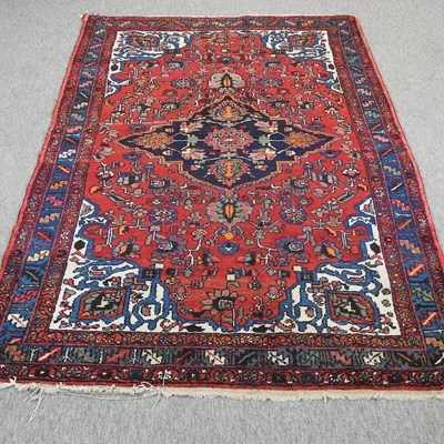 Lot 396 - A Persian style woollen rug, with a central medallion