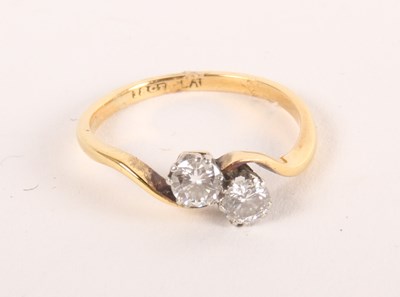 Lot 80 - An 18ct gold two-stone diamond crossover ring,...