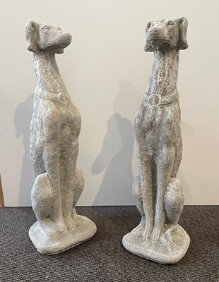 Lot 424 - A pair of reconstituted stone greyhounds h...