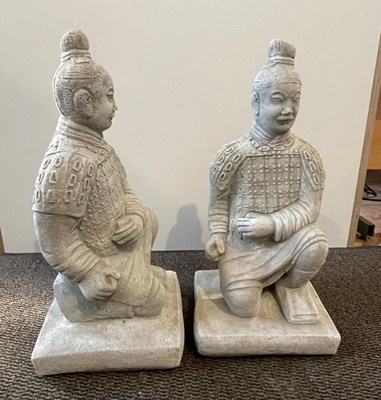 Lot 436 - A pair of reconstituted stone crouching...