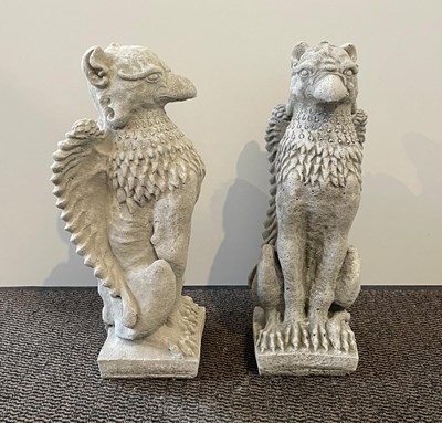 Lot 420 - A pair of reconstituted stone griffins, h 55cm,...