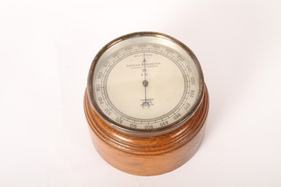Lot 364 - A Wheeler of London oak desk aneroid barometer,...