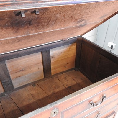 Lot 517 - An 18th century oak mule chest, the hinged lid...