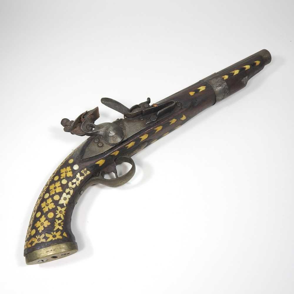 Lot 495 - A middle Eastern flintlock pistol, with bone...