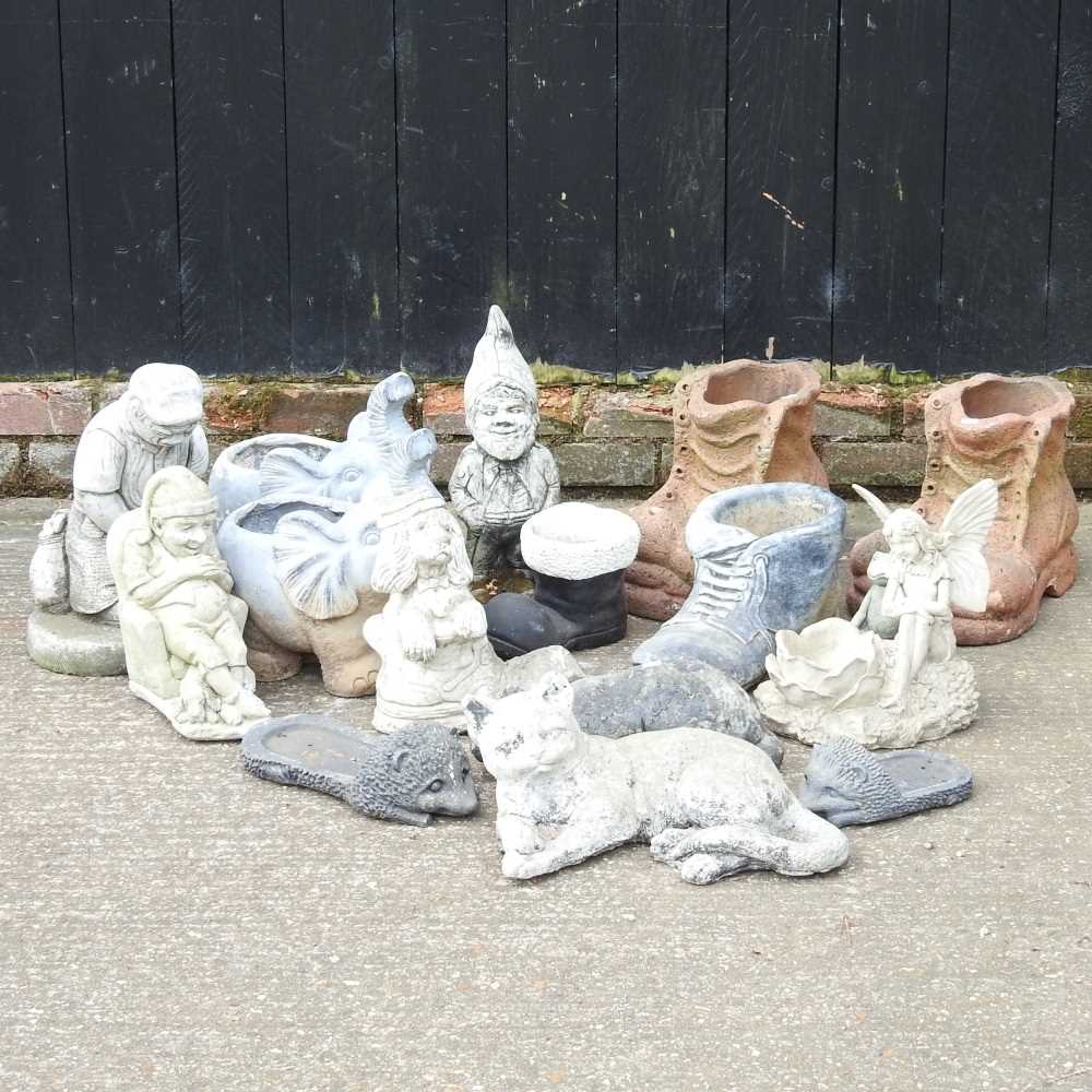 Lot 579 - A collection of cast stone garden ornaments,...