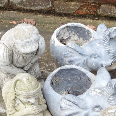 Lot 579 - A collection of cast stone garden ornaments,...