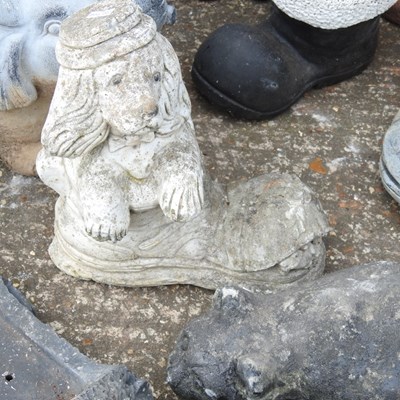 Lot 579 - A collection of cast stone garden ornaments,...