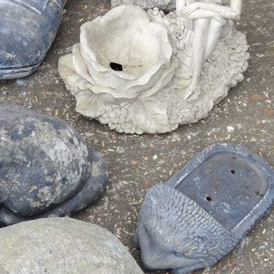 Lot 579 - A collection of cast stone garden ornaments,...