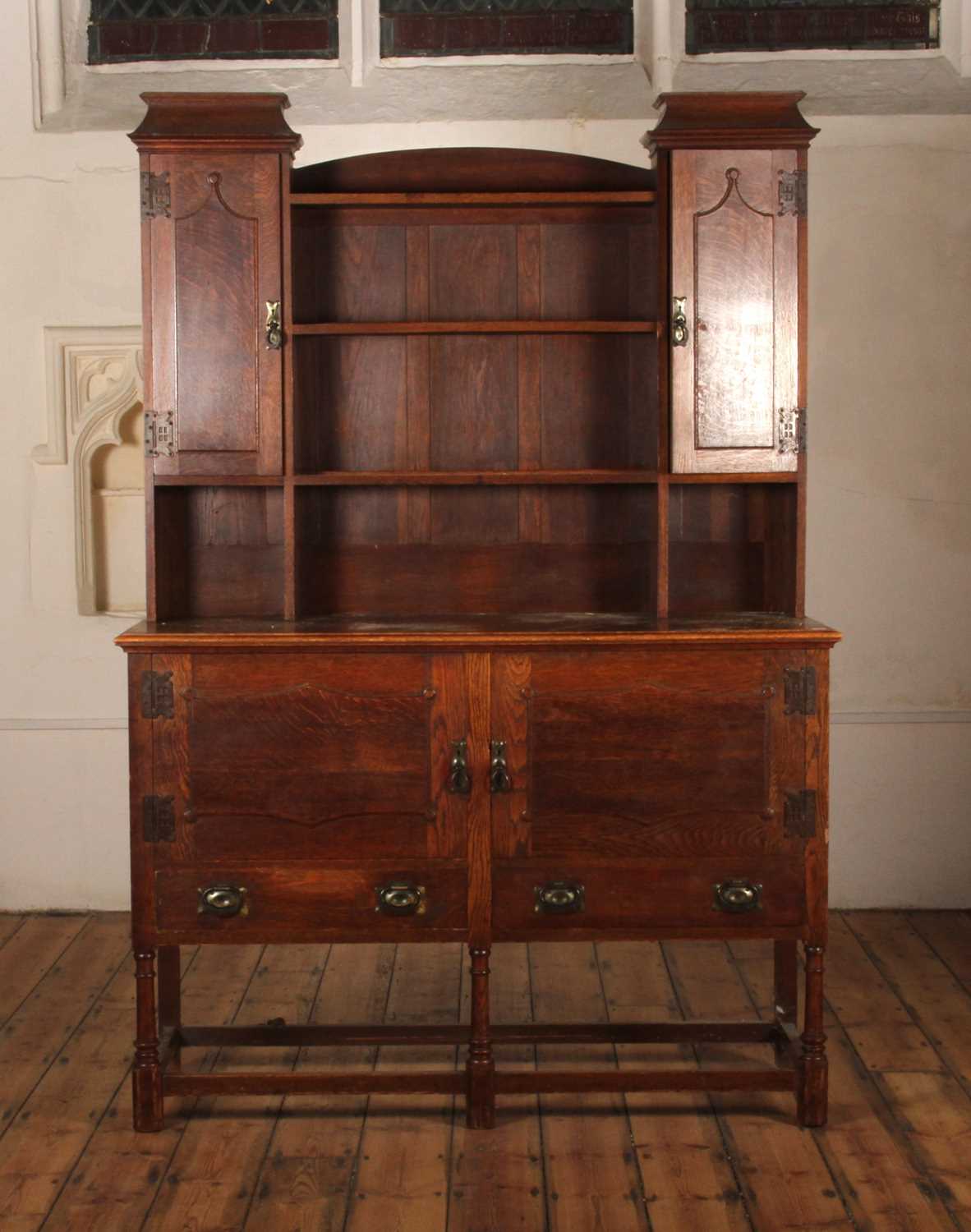 Lot 549 - An early 20th century Arts and Crafts oak...