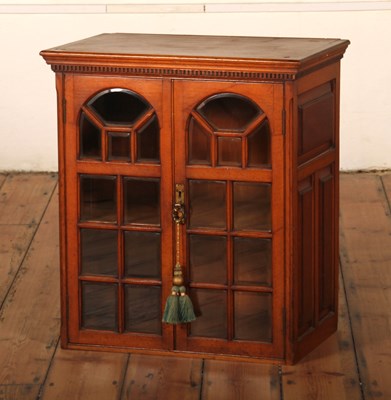 Lot 399 - An Edwardian light oak glazed cabinet, having...