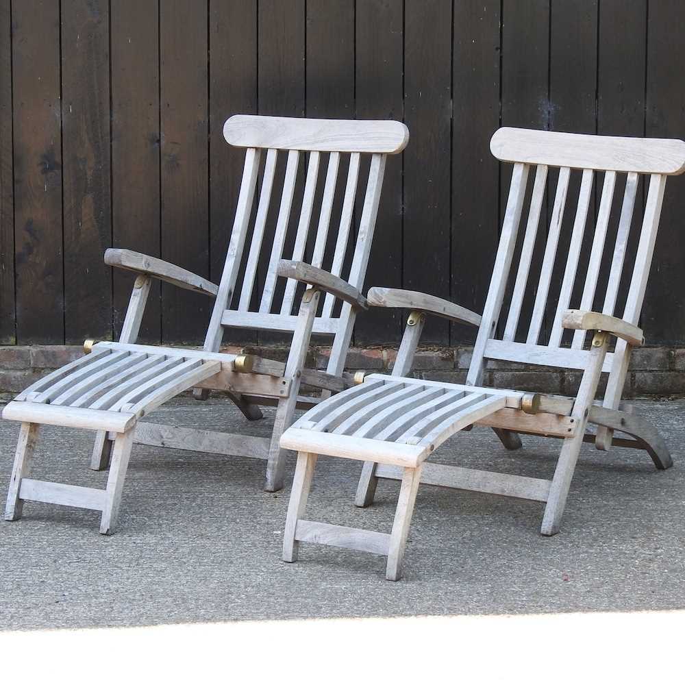 Lot 343 - A pair of teak folding garden steamer chairs