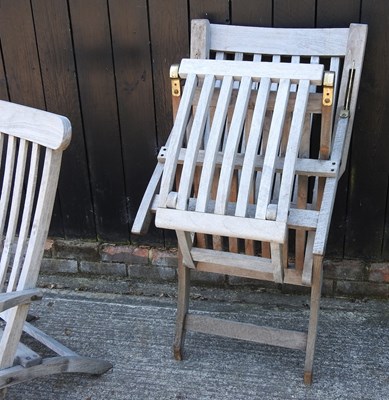 Lot 343 - A pair of teak folding garden steamer chairs