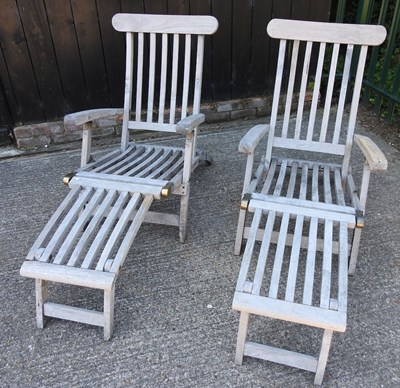 Lot 343 - A pair of teak folding garden steamer chairs