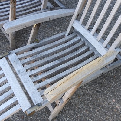 Lot 343 - A pair of teak folding garden steamer chairs