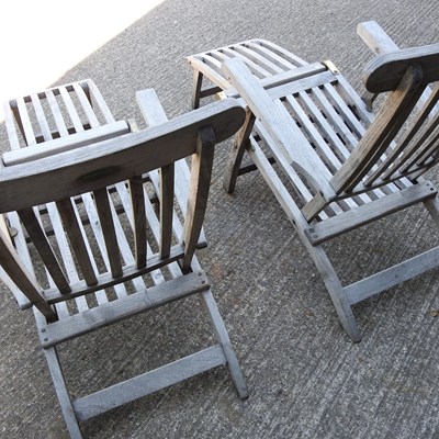 Lot 343 - A pair of teak folding garden steamer chairs