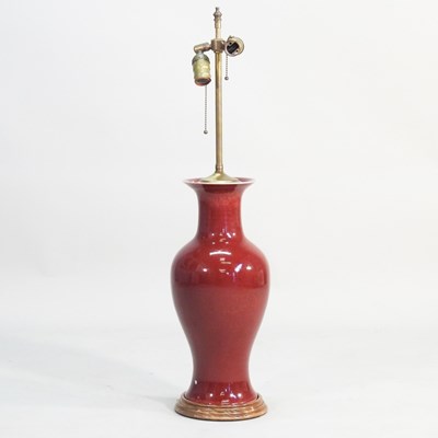 Lot 290 - A Chinese sang de boeuf glazed table lamp base,...