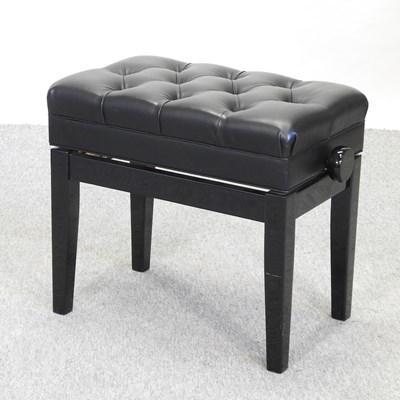 Lot 621 - A modern black upholstered piano stool