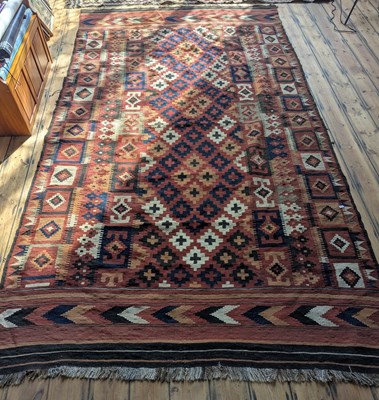 Lot 583 - A large Kelim rug, having geometric decoration...