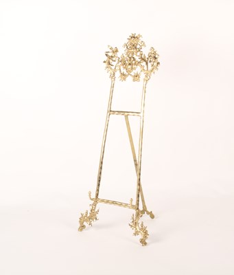Lot 235 - An ornate brass table easel, decorated with...