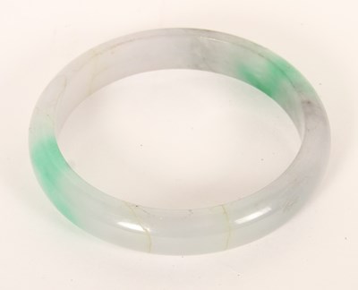 Lot 291 - A jade coloured hardstone bangle, internal...