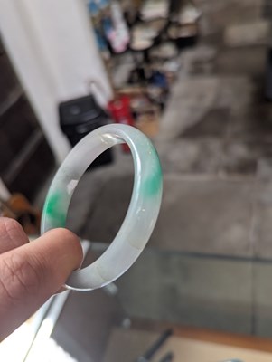 Lot 291 - A jade coloured hardstone bangle, internal...