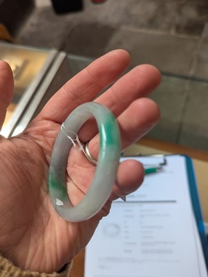 Lot 291 - A jade coloured hardstone bangle, internal...