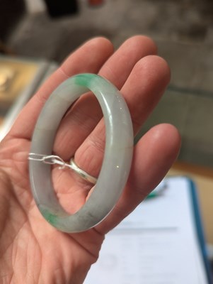 Lot 291 - A jade coloured hardstone bangle, internal...