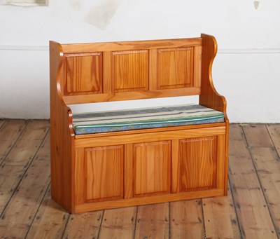 Lot 367 - A modern pine pew with a cushion over a hinged...