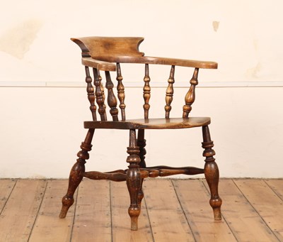 Lot 550 - An early 20th century elm seated captain's...