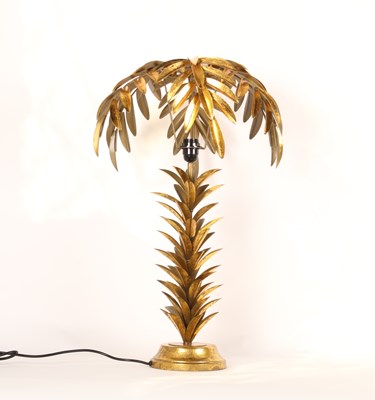 Lot 217 - A gilt metal table lamp and shade, in the form...
