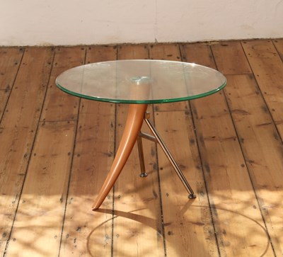 Lot 561 - A modern circular table, with a glass top