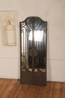 Lot 568 - A painted metal framed wall mirror, in the...