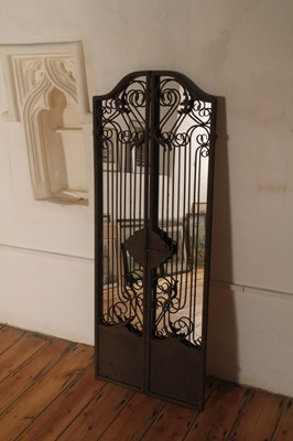 Lot 568 - A painted metal framed wall mirror, in the...
