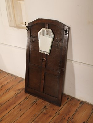Lot 587 - A 1920s oak coat rack and mirror