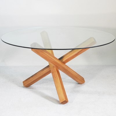 Lot 305 - A modern circular glass table, on saman wood...