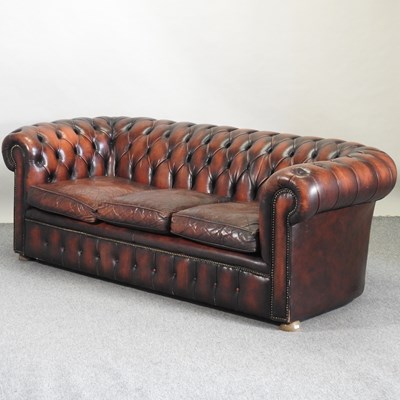 Lot 714 - A red leather upholstered button back chesterfield sofa