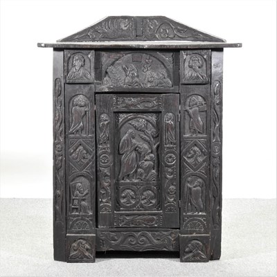 Lot 282 - A 19th century heavily carved dark oak corner cabinet