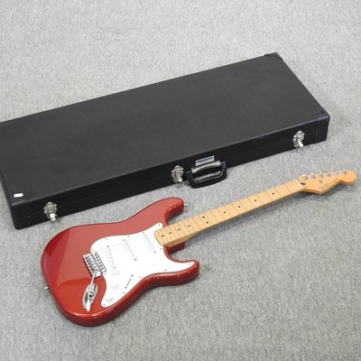 Lot 699 - A Fender Stratocaster red electric guitar