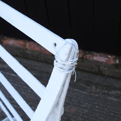 Lot 1 - A pair of Regency style white painted wrought...
