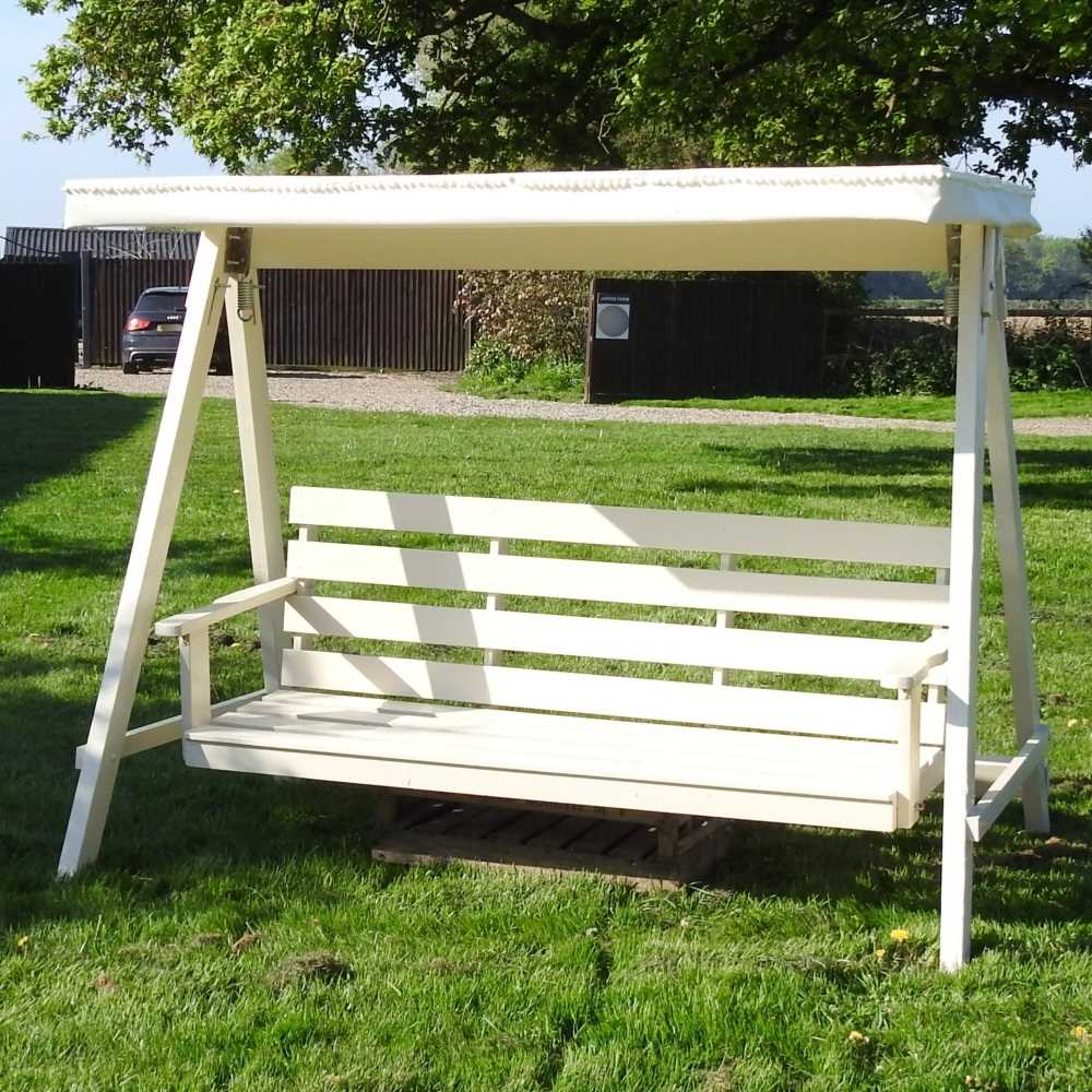 Lot 5 - A white painted wooden three seater swinging...