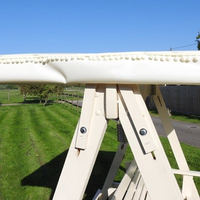 Lot 5 - A white painted wooden three seater swinging...