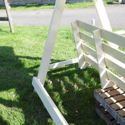 Lot 5 - A white painted wooden three seater swinging...