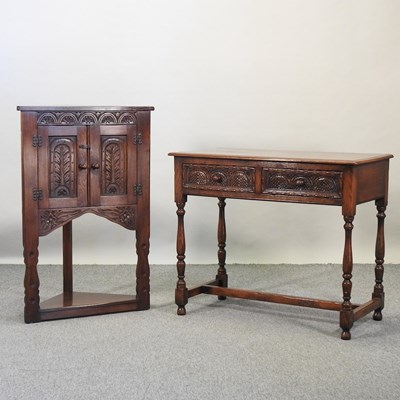 Lot 585 - A reproduction carved oak side table