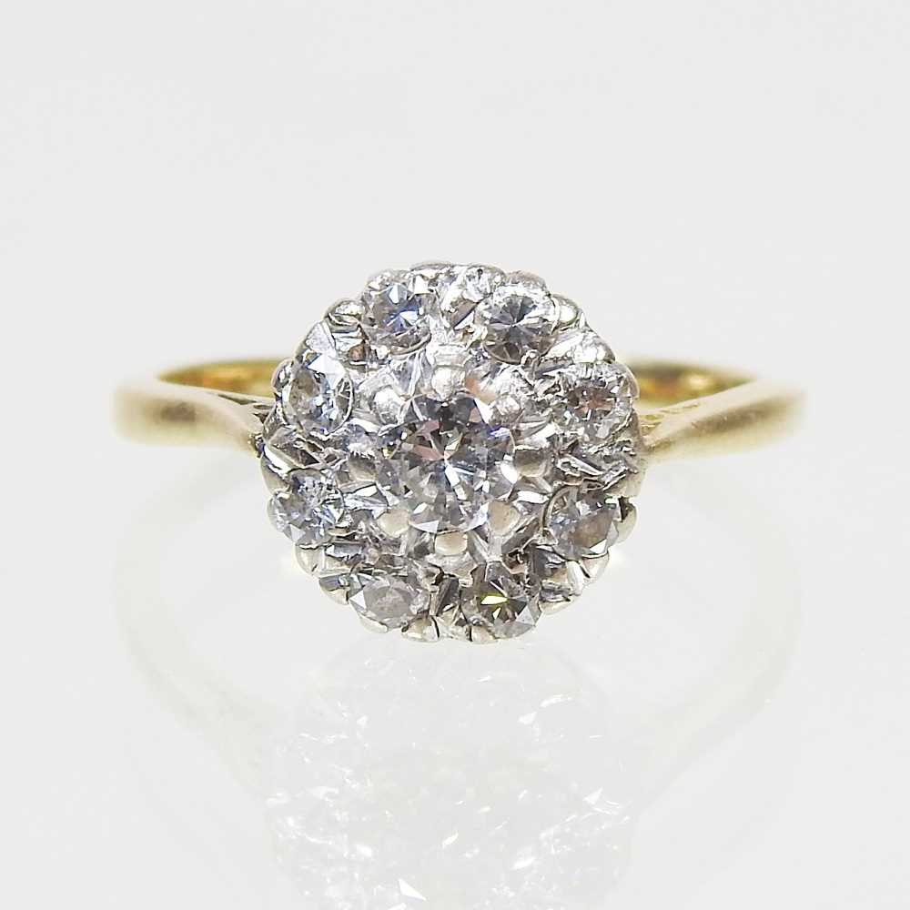 Lot 46 - An 18 carat gold illusion set diamond cluster...