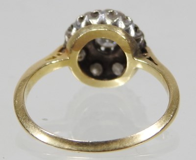 Lot 46 - An 18 carat gold illusion set diamond cluster...
