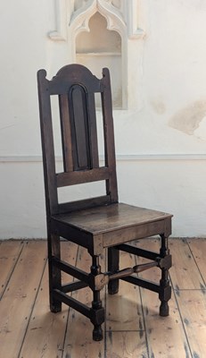 Lot 489 - An 18th century oak chair, having an arched...