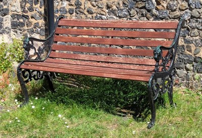 Lot 444 - A black painted metal garden bench, having...