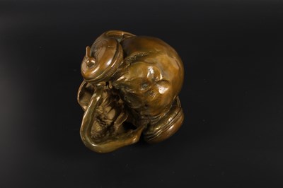 Lot 115 - A bronze model of a skull wearing headphones
