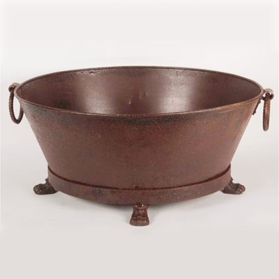 Lot 512 - A rusted metal planter, flanked by loop handles